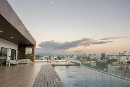 a balcony with a swimming pool on top of a building at Top Floor in Luxury Tower in Santiago de los Caballeros
