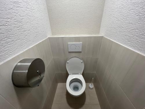 a small bathroom with a toilet in a stall at Hostel H18 in Bardejov