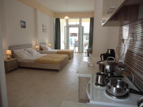 a kitchen and living room with a bed and a stove at Katerina Apartments near the Sea in Zakynthos Town