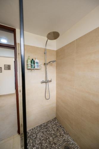 a bathroom with a shower with a glass door at Oasys House - Beautiful Private Beach Front Home in Msambweni
