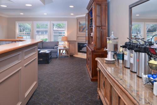 a kitchen with a counter and a living room at Sand Pebbles Inn in Cambria