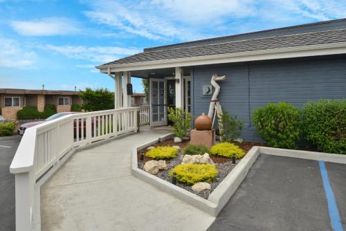 a front porch of a home with a white railing at Sand Pebbles Inn in Cambria