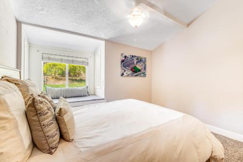 a bedroom with a large bed and a window at Wildcat Family Ranch in Murphys