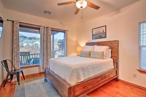 a bedroom with a bed and a ceiling fan at Updated Cabin with 360-Degree Mtn View 1 Mi to Lake in Medicine Park