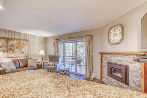 a bedroom with a fireplace and a living room at Ski House 106 - Meredith Lodging in Bend