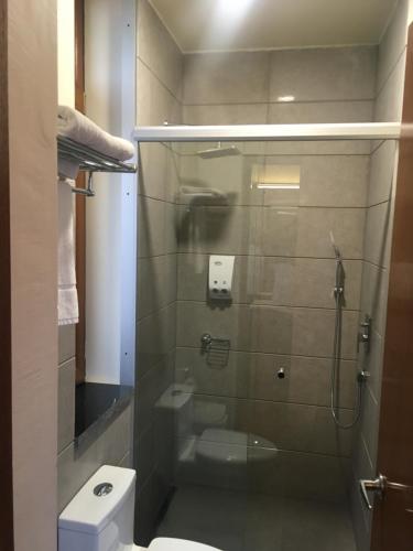 a bathroom with a glass shower with a toilet at La casa de Teresita in La Paz