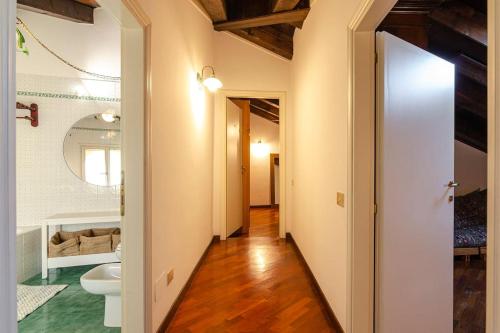 a hallway of a bathroom with a toilet and a sink at Griffoni Home, in the Heart of the City in Bologna
