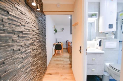 un couloir avec un mur en briques et une salle à manger dans l'établissement Paris La Villette - Charming Apartment 2 rooms, à Paris