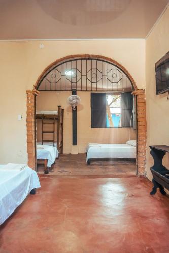 a room with two beds and a large window at Casa Colonial in Mariquita