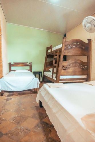 a bedroom with two bunk beds in a room at Casa Colonial in Mariquita