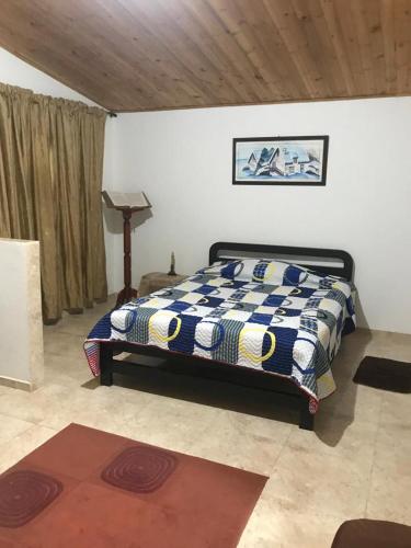 a bedroom with a bed in the corner of a room at La Isabela in Pitalito