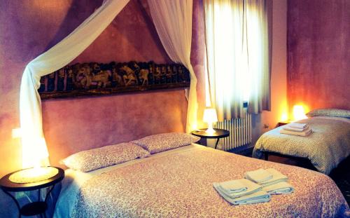 a bedroom with two beds with towels on them at B&B Amerigo Vespucci in Pescara