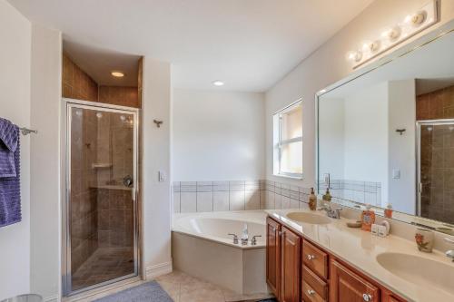a bathroom with a tub and a sink and a shower at Naples Oasis in Naples