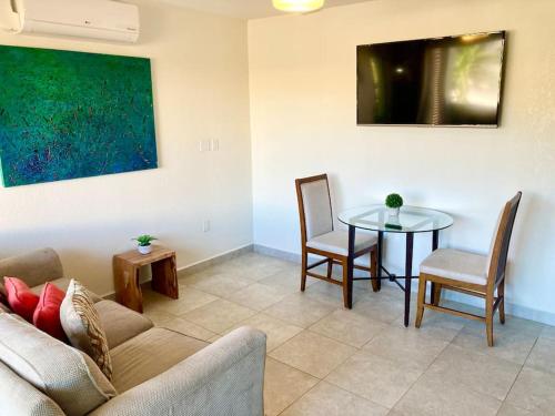 a living room with a couch and a table at Luxurious 1 bedroom Apt with pool in Simpson Bay in Koolbaai