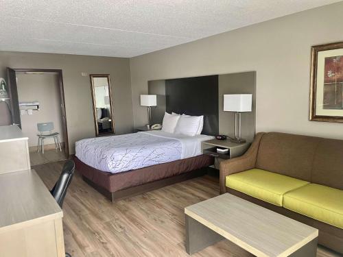 a hotel room with a bed and a couch at Best Western - Fayetteville in Fayetteville