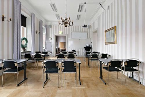 an empty room with tables and chairs in it at Nora Stadshotell, Sure Hotel Collection by Best Western in Nora