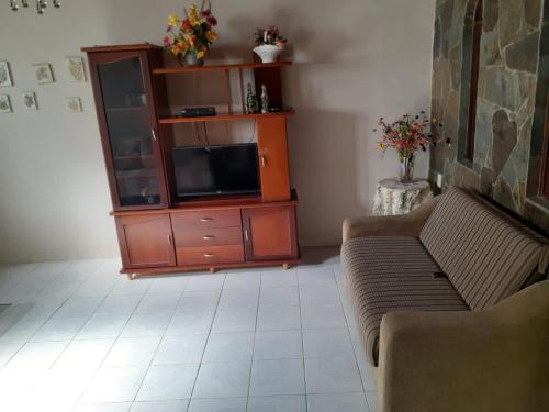 salon z telewizorem i kanapą w obiekcie Casa de Lençóis w mieście Lençóis