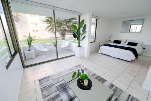 een slaapkamer met een bed en een groot raam bij La Serena - Departamento Frente al Mar in La Serena