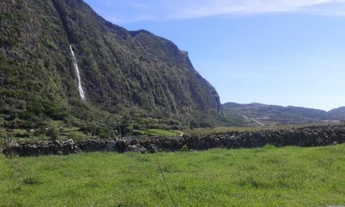 a waterfall on the side of a mountain at Residencia Mateus in Faja Grande