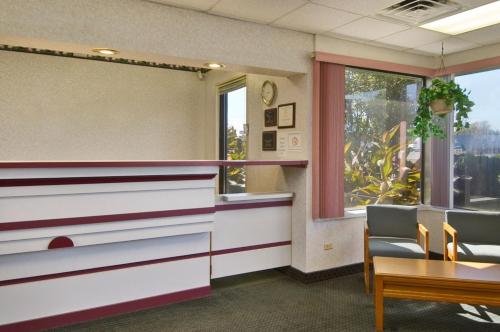 a waiting room with a counter and a window at Travelodge by Wyndham Ridgeway Martinsville Area in Martinsville
