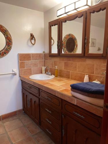 a bathroom with a sink and a mirror at Baja Azul in Ensenada