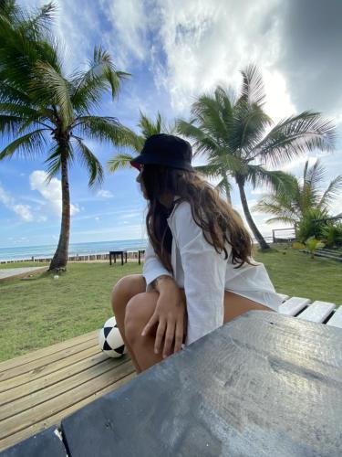 a girl sitting on a table with a soccer ball at Aytyaram in Taipu