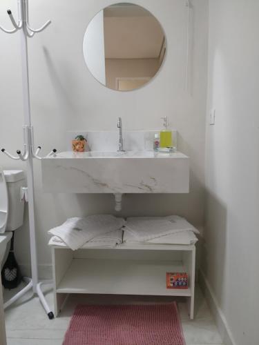 a bathroom with a sink and a mirror at A Pousadinha in Águas de São Pedro