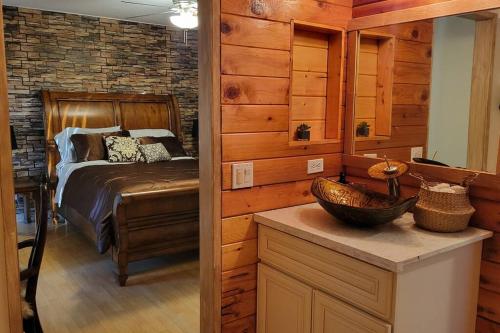 een slaapkamer met een bed en een houten muur bij Special Vacation House/ Pool & Basketball Court in El Cajon