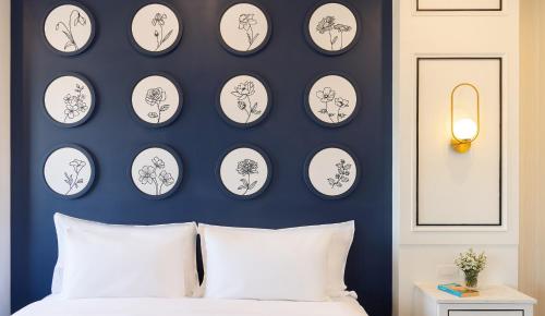 a bedroom with black and white plates on the wall at Eastin Hotel Vientiane in Vientiane