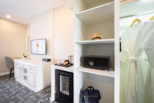 a living room with a fireplace and a desk at Eastin Hotel Vientiane in Vientiane