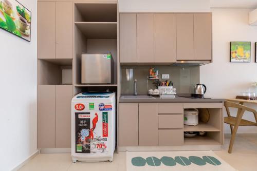 a kitchen with a refrigerator in the middle of a kitchen at Căn hộ Studio The Sóng Vũng Tàu in Vung Tau