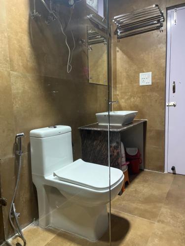 a bathroom with a toilet and a sink at Calm Paradise in Shimla