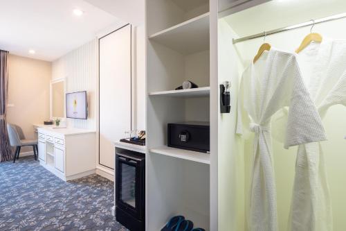 a room with a fireplace and a room with a desk at Eastin Hotel Vientiane in Vientiane