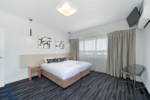 a hotel room with a bed and a window at Prince of Wales Hotel in Brisbane