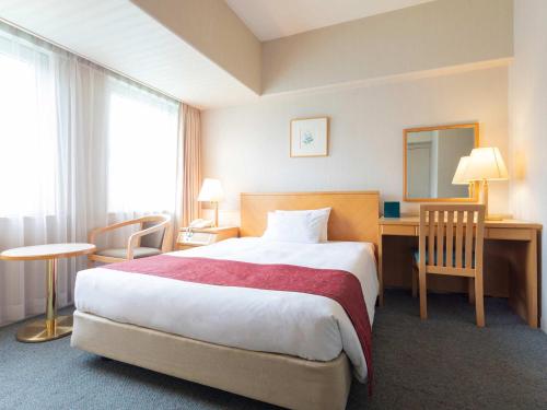 Postel nebo postele na pokoji v ubytování The Saihokukan Hotel