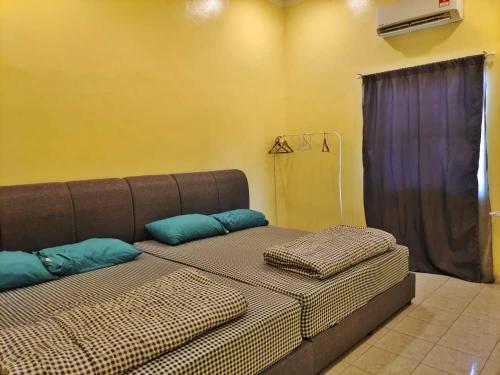 a bed with two pillows on it in a room at Melaka AFamosa Pool Villa The Moments Villa Lot 1319 Homestay in Kampong Pulau Sebang