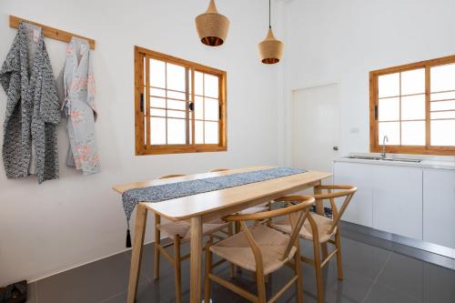 a kitchen with a wooden table and chairs at Villa Sunrise Garden A181 in Thalang