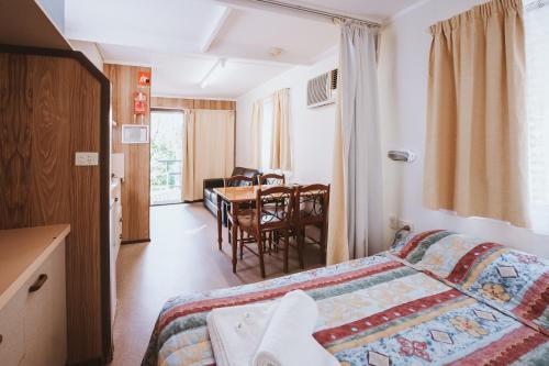 a hotel room with a bed and a table at BIG4 Breeze Holiday Parks - Cania Gorge in Cania