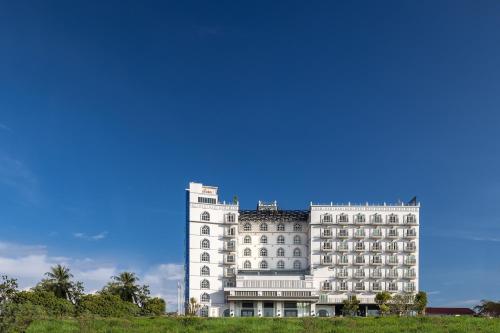 a large white building with a blue sky in the background at Eastin Hotel Vientiane in Vientiane