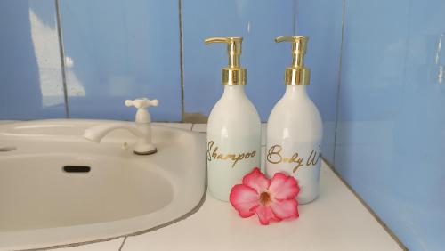 two bottles on a bathroom counter next to a sink at Nusa Indah Bungalows in Gili Islands