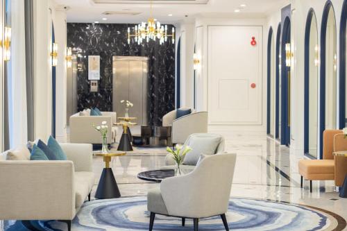 a lobby of a hotel with chairs and tables at Eastin Hotel Vientiane in Vientiane