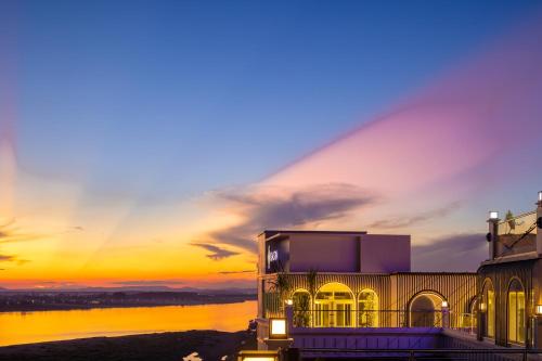 a building with a sunset in the background at Eastin Hotel Vientiane in Vientiane