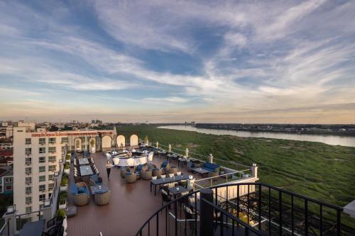 a view of a balcony of a building with tables and chairs at Eastin Hotel Vientiane in Vientiane