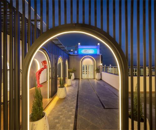 an archway leading to a building with potted plants at Eastin Hotel Vientiane in Vientiane