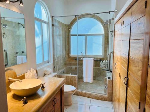 a bathroom with a sink and a toilet and a shower at Villa Martha Garza Blanca - Heated Pool, Chef & Full Staff Included in Puerto Vallarta