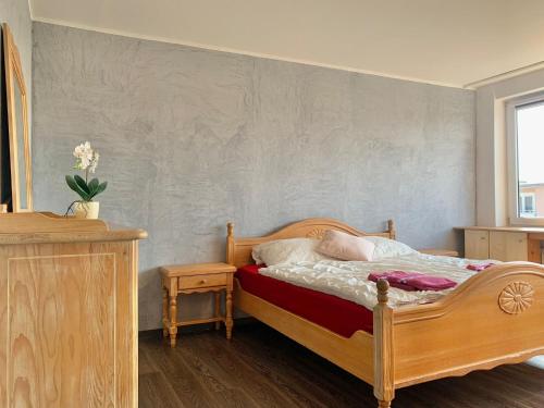 a bedroom with a wooden bed and a wall at Vivi in Wolfenbüttel