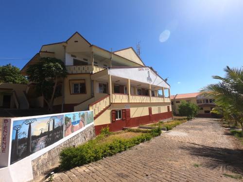 a building on the side of a brick road at Centre Lucien Botovasoa in Diego Suarez