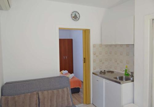 a kitchen with a sink and a counter top at Apartments Tomislav - 120 m from beach in Okrug Donji