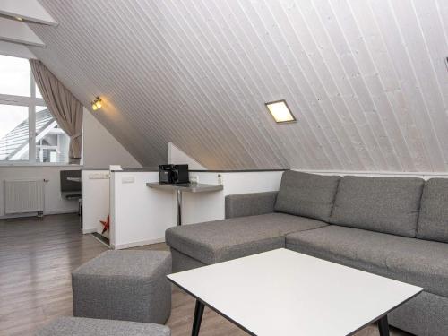 a living room with a couch and a table at Two-Bedroom Holiday home in Wendtorf 34 in Wendtorf