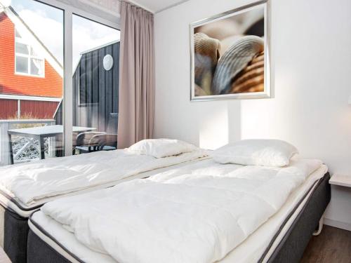 a large bed in a room with a window at Two-Bedroom Holiday home in Wendtorf 38 in Wendtorf